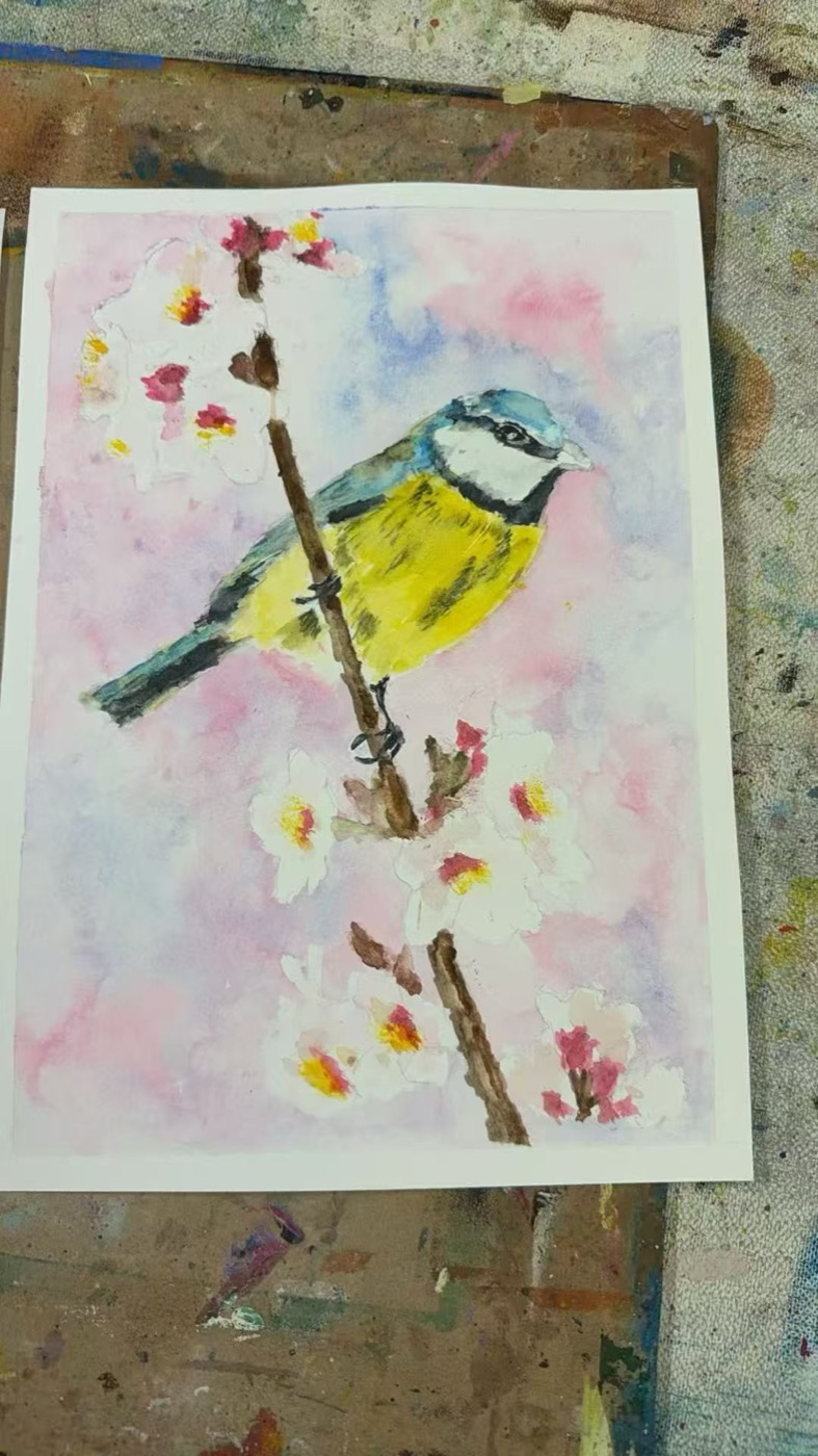 Watercolour of a small bird on a blossom branch